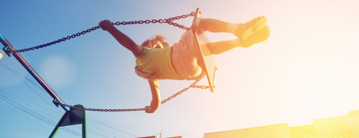 child swinging in the sun