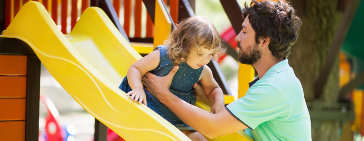 toddler on slide with parent